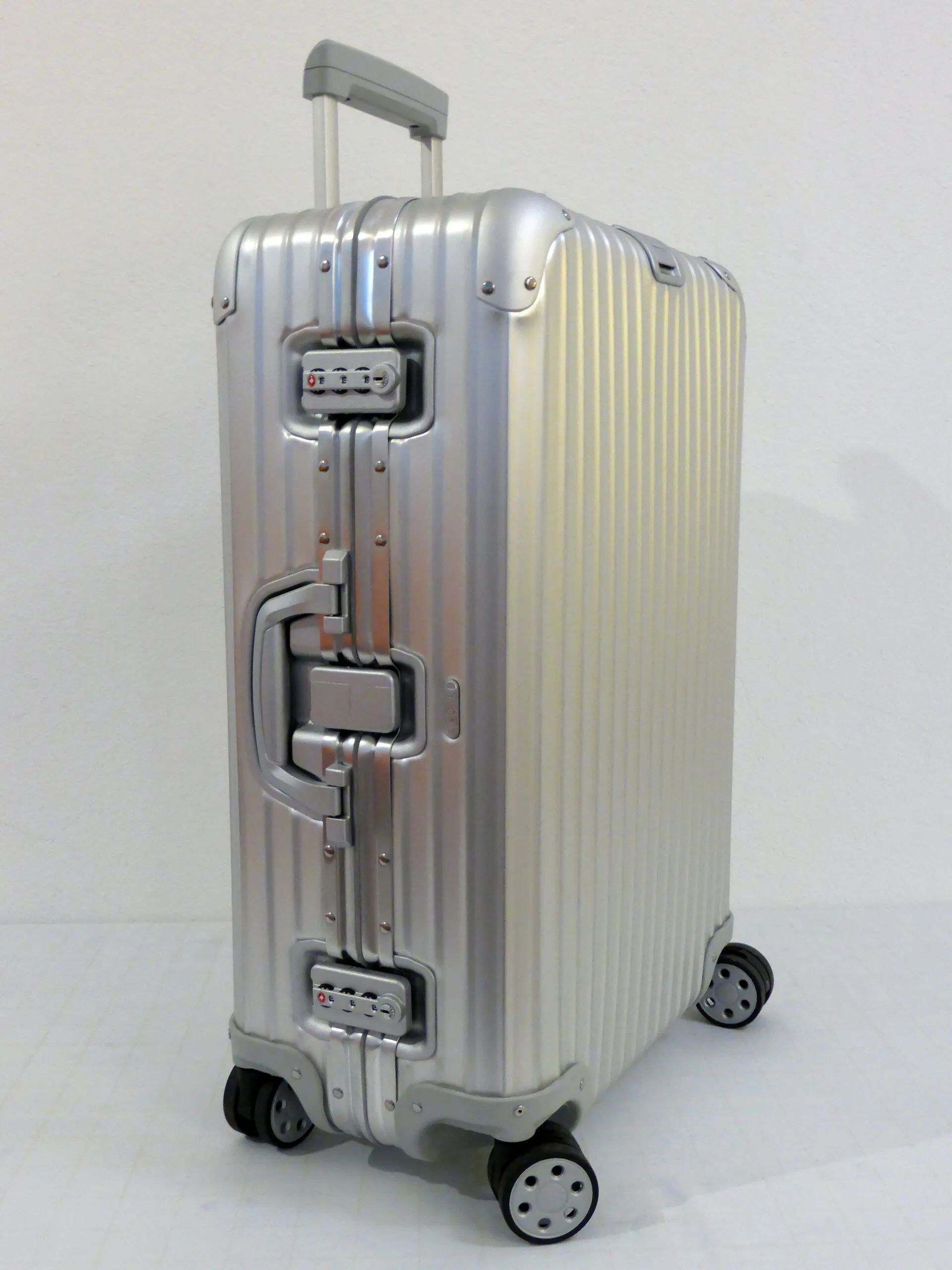 A modern wheeled suitcase — wheels (5,000 years old) plus luggage (centuries old), combined only in 1970.